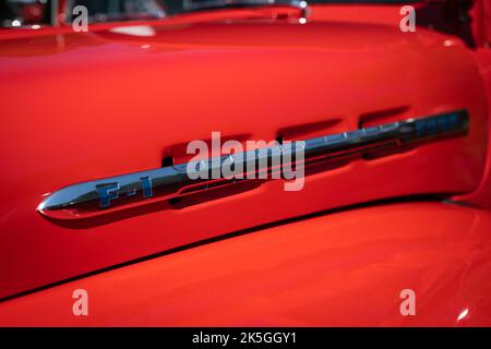 NISSWA, MN - 30 JUL 2022: Closeup detail of Ford F1 chrome emblem on a restored antique pickup truck on a sunny day. Stock Photo