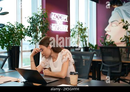 Weary company employee suffering from headache in workplace Stock Photo