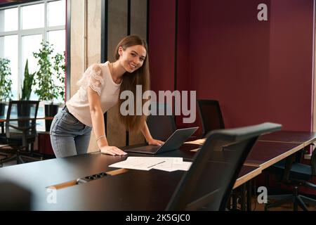 Cheerful corporate worker posing for camera at work Stock Photo