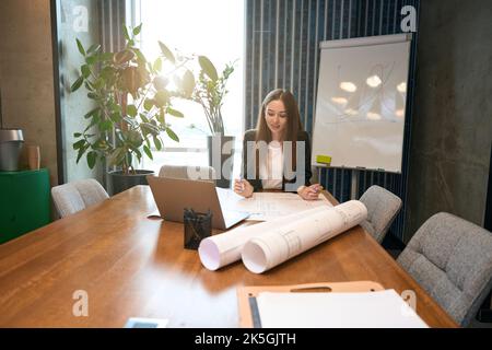 Concentrated design professional is analyzing building plan Stock Photo