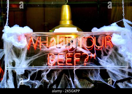 what's your beef neon restaurant sign with spider web background for Halloween Stock Photo