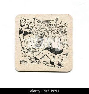 A vintage beer mat promoting the English beer, Newcastle Brown Ale. Decorated with an amusing cartoon image by Terence ‘Larry’ Parkes depicting men in a tug-of-war competition, battling over a bottle of beer. Likely to date from the 1970s or 1980s. Stock Photo