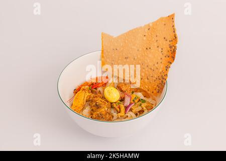 Mi Quang, Vietnamese rice noodles with meat, chicken stock, shrimp, egg, Vietnamese food isolated on white background, perspective view Stock Photo