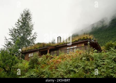 Grass roofing on a house in Olden Norway. Wooden cabin house with grass roof. Green roof cabin. Eco, sustainable housing. Environmental development. Stock Photo