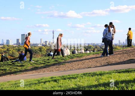 London, UK 8th October 2022. Primrose Hill in north London busy with people enjoying the mini-heatwave and autumn colours. While not quite sunbathing weather, you might be able to hold off from switching on the heating for a bit longer. Credit: Monica Wells/Alamy Live News Stock Photo