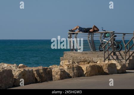 Tel Aviv, Israel - September 15th, 2022: A young man, sitting on the ...