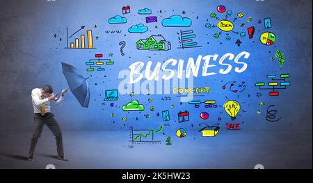 businessman hiding behind umbrella concept Stock Photo