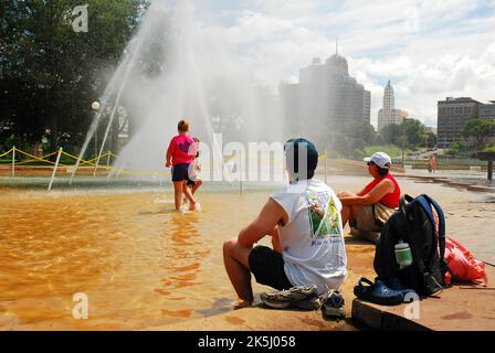 A Family Cools Off on a Hot Summer Day at a water fountain at Mud Island park in Memphis Tennessee Stock Photo