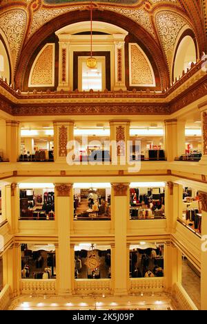 The interior  multi storied Atrium of Macys, formerly Marshall Fields Department Store in Chicago is decorated with mosaics and tiles on the walls Stock Photo