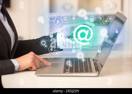 Hands working on laptop with digital icons concept Stock Photo