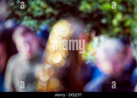 Colourful crowd in the city, abstract, sunlight, golden twinkling lights, bokeh, symbolic image, wallpaper Stock Photo