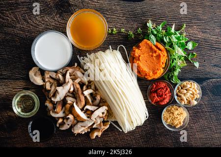 Spicy Thai Curry Pumpkin Noodle Soup Ingredients: Pumpkin puree, rice noodles, and other raw ingredients for curry Stock Photo
