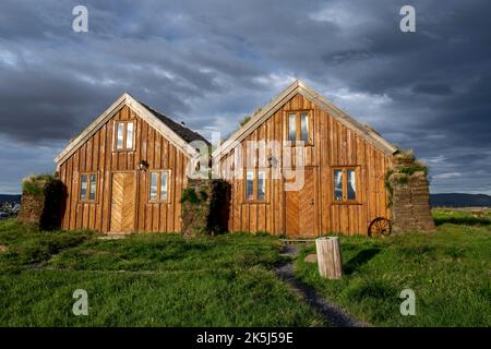 Traditional wooden peat houses with grass on the roof, in the evening light, Moeorudalur, Icelandic highlands, Iceland Stock Photo