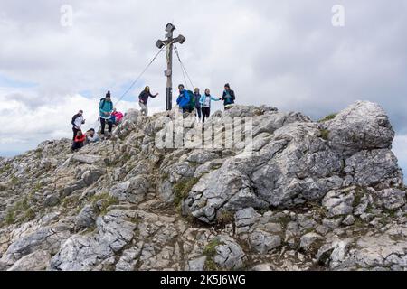Many hikers at the summit of Breitenstein, Fischbachau, Mangfall Mountains, Upper Bavaria, Germany Stock Photo