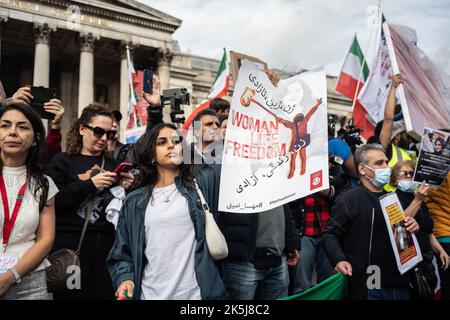 Protestors gathered in Trafalgar Square, demonstrating against the death of Mahsa Amini who died whilst been detained by the Iranian police. Stock Photo