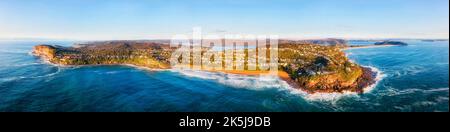 Scenic Northern Beaches pacific coast in Sydney of Australia - wide aerial panorama from open sea to Whale beach. Stock Photo