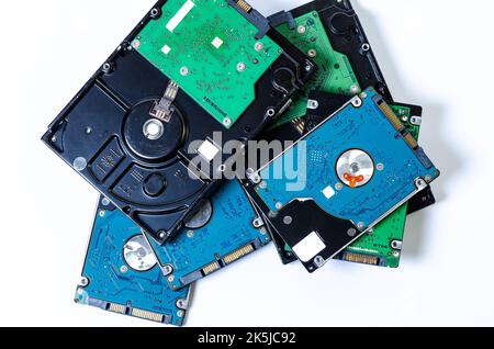 Hard disk drive HDD of different size isolated on white. Detailed view of the inside of a hard disk drive HDD Hard Drives data storage side by side wi Stock Photo