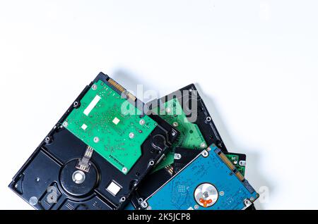 Hard disk drive HDD of different size isolated on white. Detailed view of the inside of a hard disk drive HDD Hard Drives data storage side by side wi Stock Photo