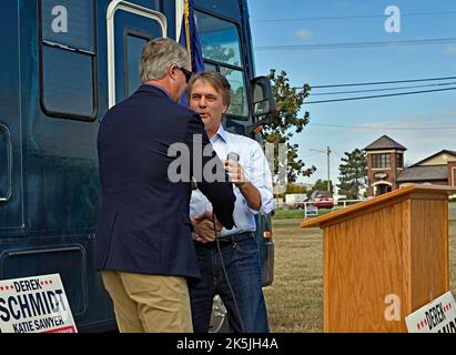 EMPORIA, KANSAS - OCTOBER 8, 2022 Former Kansas Governor Dr. Jeff Colyer  shakes hands with US Senator Dr. Roger Marshall who will introduce him to the supporters that turned out to greet the KSGOP election bus tour at the Lyon County fairgrounds Stock Photo