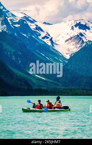 Colorful kayakers; Chilkoot Lake; Chilkoot State Recreation Site; Coast Mountains; Haines; Alaska; USA Stock Photo