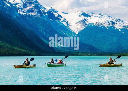 Colorful kayakers; Chilkoot Lake; Chilkoot State Recreation Site; Coast Mountains; Haines; Alaska; USA Stock Photo