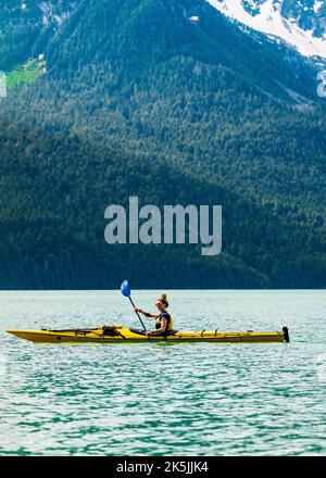 Colorful kayakers; Chilkoot Lake; Chilkoot State Recreation Site; Coast Mountains; Haines; Alaska; USA Stock Photo