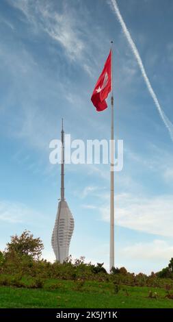 Turkish flag at Camlica Park with Kucuk Camlica TV Radio Tower, or Kucuk Camlica TV Radyo Kulesi in the background in a summer day, Uskudar district, Istanbul, Turkey Stock Photo