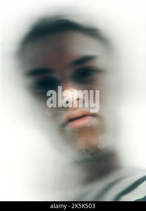 Everythings blurry. Blurry low-angle view of a young mans face. Stock Photo