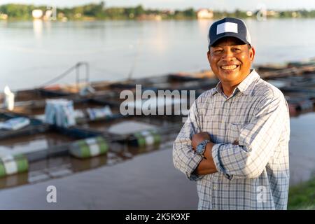 Aquaculture farmers at ponds and cages. Tilapia fish. Tilapia Farming. Stock Photo