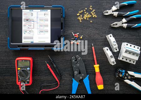 Different electrical tools and digital tablet on wooden background, flat lay. Stock Photo