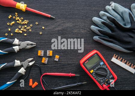 Different electrical tools on wooden background, flat lay. Stock Photo