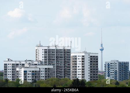 Prefabricated high-rise buildings in Gropiusstadt with the Berlin TV tower Stock Photo