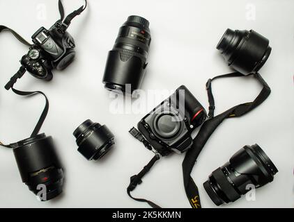 Camera lens and body are scattered on white background Stock Photo