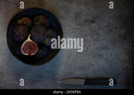 Figs in Plate on gray stone table Stock Photo