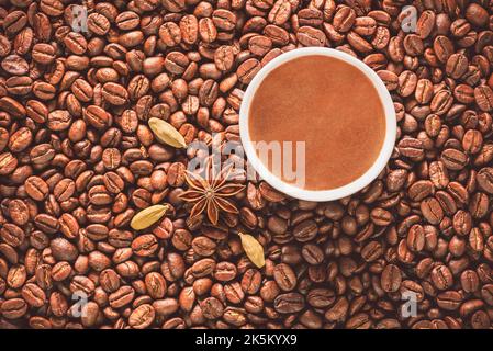 Turkish coffee cup on roasted coffee beans. Top view with close up. Stock Photo