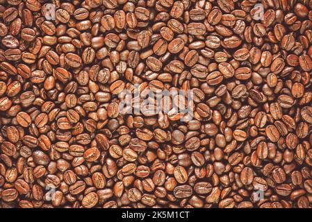 Roasted coffee beans background. Top view with copy space. Stock Photo