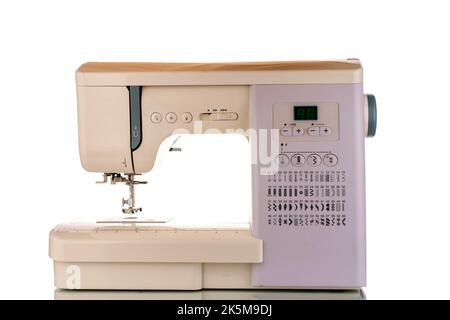 One electric sewing machine, macro, isolated on white background. Stock Photo