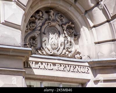 Carved stonework above the entrance of an Inland Revenue UK government tax office. Stock Photo