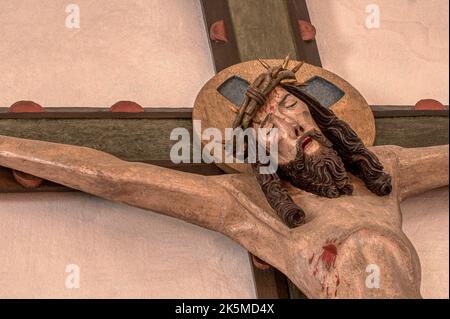 medieval wooden crucifix with the suffering Christ in Kirke Hyllinge church, Denmark, October 4, 2022 Stock Photo
