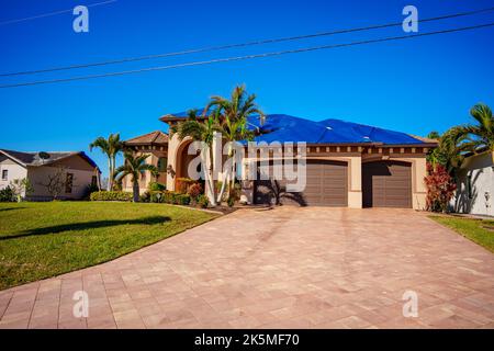 Punta Gorda, FL, USA - October 8, 2022: House in Punta Gorda Florida with blue tarp on roof from heavy winds Hurricane Ian Stock Photo