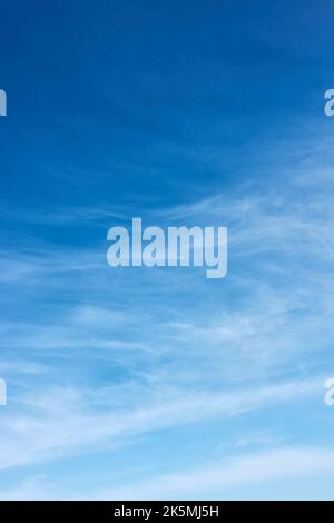 Blue sky with white fleecy clouds  - vertical background with space for your own text Stock Photo