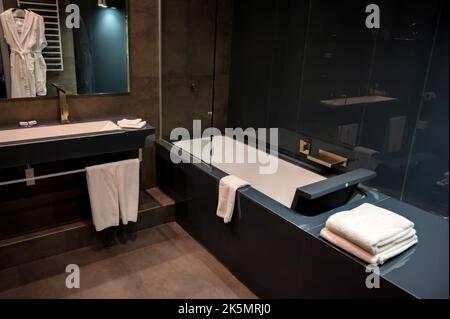 Modern Interior of bathroom with sink of dark tiles Stock Photo