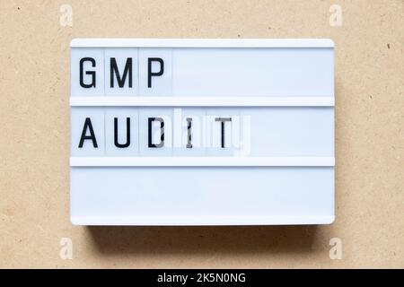Lightbox with word GMP (Good manufacturing practice) audit on wood background Stock Photo