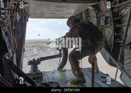 Yuma, United States. 06 October, 2022. U.S. Marines Corps Sgt. Juan Gutierrez with Marine Medium Tiltrotor Squadron 268, Marine Aircraft Group 24, 1st Marine Aircraft Wing, fires an M240D 7.62mm machine gun out of an MV-22 Osprey aircraft during Weapons and Tactics Instructors course at Goldwater Air Force Range, October 6, 2022 near Yuma, Arizona. Stock Photo