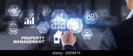 Businessman working on a virtual screen inscription: Property management Stock Photo