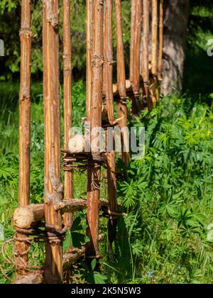 The roundpole fence is a wooden fence typical to the countryside in Sweden, Norway, Finland and Estonia. It is normally made from unbarked and unsplit Stock Photo