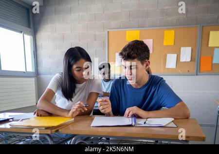 Two teenage students working as a team in a class at high school. education concept Stock Photo