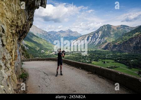 Male road cyclist photographing the balcony road from Bourg d'Oisans to Villard Notre Dame, French Alps. Stock Photo