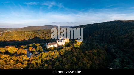 Lockenhaus, Austria - 7 October, 2022: panorama of Lockenhaus Castle surrounded by autumn forest in warm evening light Stock Photo