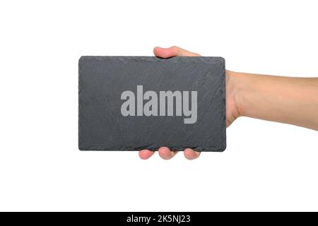 Grey stone slate cutting board with an empty space for text, in hand, on white background Stock Photo
